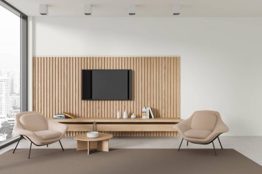 Modern oturma odasının içinde beyaz ve ahşap duvarlar, beton zemin, yuvarlak sehpanın yanında duran iki rahat bej koltuk ve duvarda televizyon. 3d oluşturma