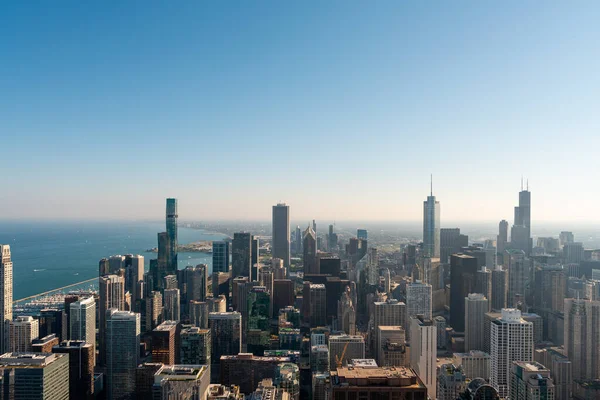 Chicago skyline with office buildings, business cityscape architecture and lake Michigan with blue sky. Aerial drone footage. Illinois, USA, North America