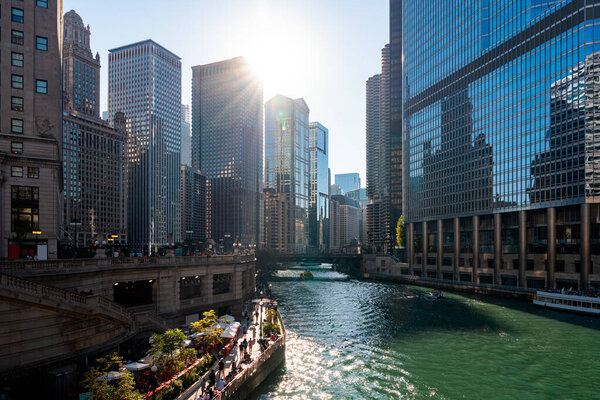 Chicago downtown district with office buildings and river embankment, business skyscrapers and city architecture on a sunny day. Illinois, USA, North America