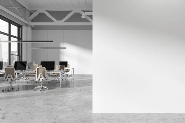 Copy space wall in modern open space office with white walls, concrete floor and row of white computer tables with beige chairs. 3d rendering