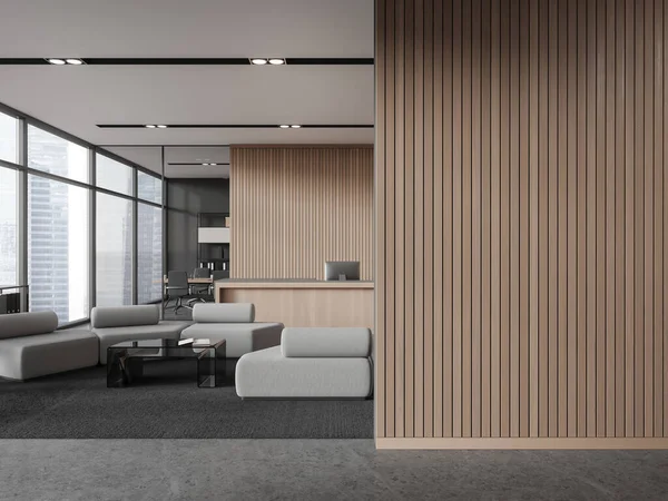 Interior of modern office hall with gray and wooden walls, concrete floor, cozy wooden reception counter with computers and white armchairs for visitors. Copy space wall. 3d rendering
