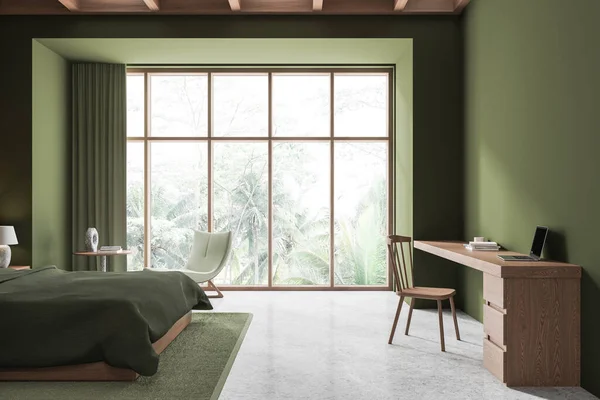 Interior of stylish bedroom with green walls, concrete floor, comfortable king size bed with green cover and cozy workplace with wooden table and chair. 3d rendering