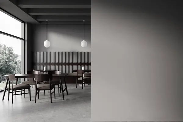 Interior of stylish restaurant with gray walls, concrete floor, cozy sofa and square and rectangular tables with chairs. Copy space wall to the right. 3d rendering