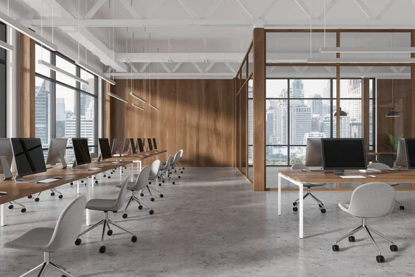 White and wooden office interior with coworking space, pc computers on tables in row. Glass conference zone with panoramic window on Bangkok skyscrapers. 3D rendering