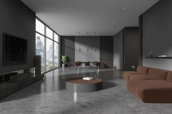 Dark home living room interior with dining table with chairs, grey concrete floor. Brown sofa and tv display with soundbar, panoramic window on Bangkok skyscrapers. 3D rendering