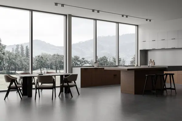 Modern home kitchen interior with bar island, side view dining and cooking corner with shelves on grey concrete floor. Panoramic window on countryside. 3D rendering
