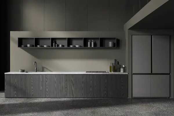 Interior of stylish kitchen with dark green walls, concrete floor, comfortable gray cabinets with built in cooker and sink and big refrigerator. 3d rendering