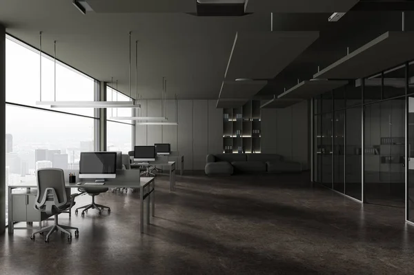 Dark business interior with coworking and relax place with sofa, pc computers on desk in row. Glass conference room and panoramic window on Paris skyscrapers. 3D rendering