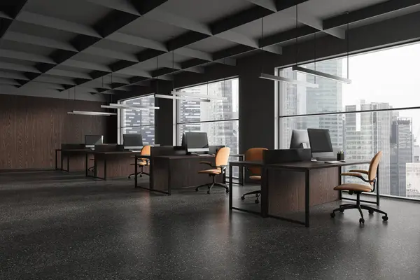 Stylish coworking interior with pc computers on work table in row, side view grey granite floor. Minimalist work corner with panoramic window on Bangkok skyscrapers. 3D rendering