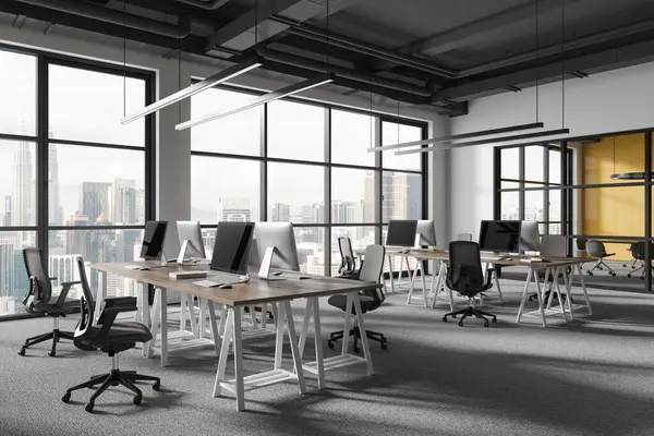 Corner of modern open space office with white and yellow walls, carpeted floor and row of computer tables with chairs. 3d rendering