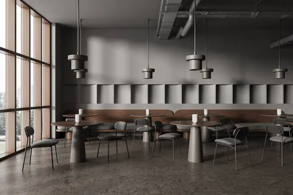Interior of modern restaurant with gray walls, concrete floor, round tables with cozy sofas and comfortable chairs. 3d rendering