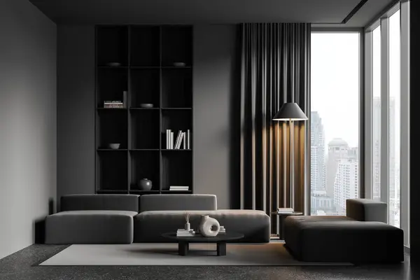 Dark home living room interior with grey sofa, carpet on grey granite floor. Shelf and coffee table with books and decoration. Panoramic window on Bangkok skyscrapers. 3D rendering