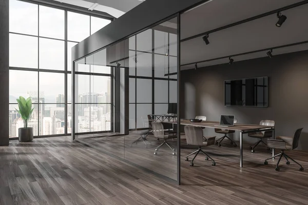Corner of stylish meeting room with brown and glass walls, wooden floor, long conference table with chairs and TV set on the wall. 3d rendering