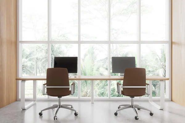 Wooden and white office loft interior with two pc monitors, coworking space with armchairs and shared desk on light concrete floor. Panoramic window on tropics. 3D rendering