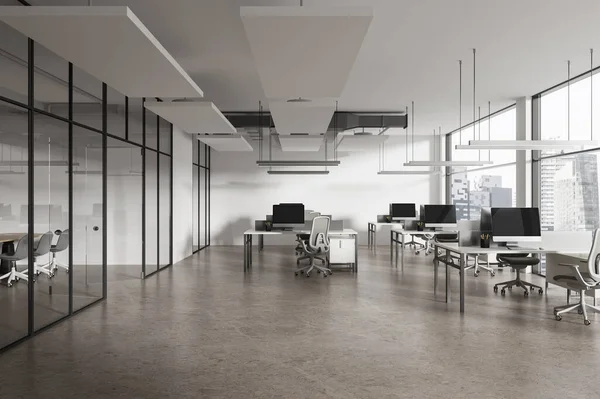 Interior of modern open space office with white walls, concrete floor, row of computer desks with white chairs and conference room next to it. 3d rendering