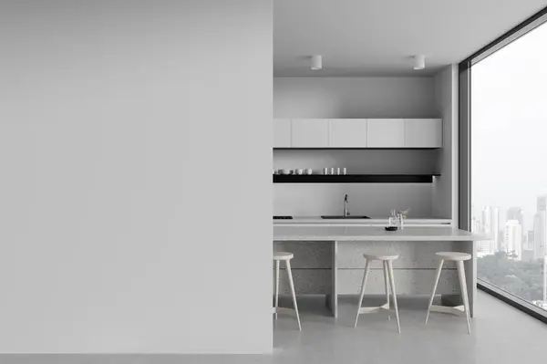 Interior of stylish kitchen with white walls, concrete floor, white cupboards and cabinets with built in cooker and sink and cozy white island with stools. Copy space wall on the left. 3d rendering