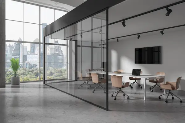 Corner of modern meeting room with white and glass walls, concrete floor, long conference table with chairs and TV set on the wall. 3d rendering