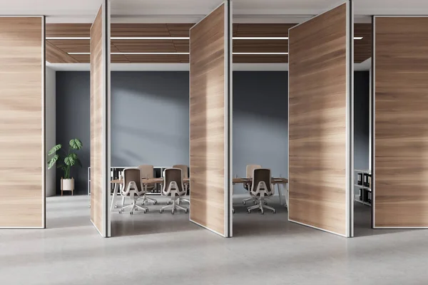 Stylish office interior with conference table and armchairs, sideboard with folders on light concrete floor. Meeting room behind wooden sliding doors. 3D rendering