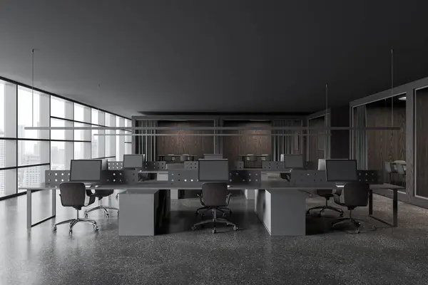 Dark office interior with pc computers on shared tables with divider. Coworking open space and small glass meeting boxes in row, panoramic window on skyscrapers. 3D rendering