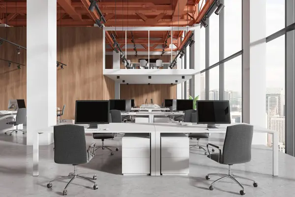 Stylish office interior with pc computers and shared desk in row, concrete floor. Two-storey stylish coworking space with panoramic window on Kuala Lumpur skyscrapers. 3D rendering