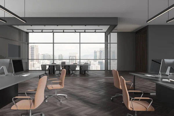 Dark corporate loft interior with coworking zone, pc computers on desk and armchairs in row. Glass conference room with board and tv screen, panoramic window on Kuala Lumpur. 3D rendering
