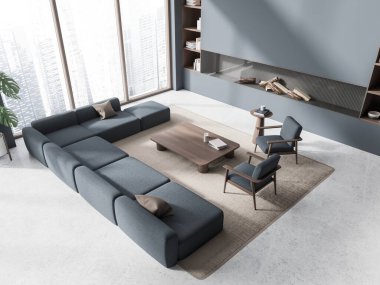 Top view of stylish chill room interior with sofa and armchairs, fireplace and coffee table with decoration, carpet on grey concrete floor. Panoramic window on Singapore. 3D rendering