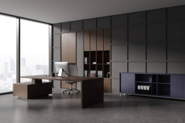 Dark office interior with pc computer on desk, side view armchair on grey concrete floor. Modern cozy ceo corner with workplace. Panoramic window on Paris skyscrapers. 3D rendering