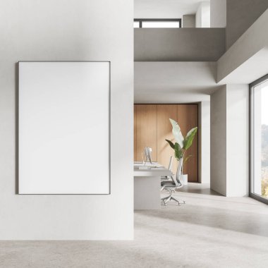 Two-storey coworking interior with armchairs, desk with pc monitors in row and panoramic window on countryside. Mock up canvas banner on partition. 3D rendering