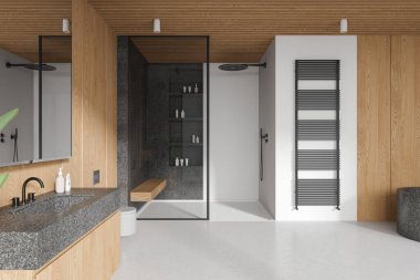 White and wooden hotel bathroom interior sink and toilet, glass shower with shelf and accessories. Modern bathing space and bathtub on concrete floor. 3D rendering