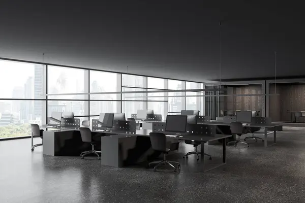 Dark office interior with coworking corner, side view pc computers on shared tables with divider. Glass meeting boxes with curtains. Panoramic window on Bangkok skyscrapers. 3D rendering