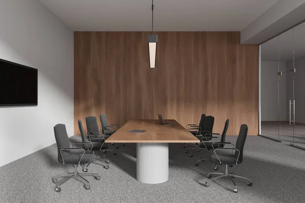 Stylish minimalist conference interior with board, laptop and armchairs on carpet. Glass meeting space with minimalist furniture and tv display on wall. 3D rendering