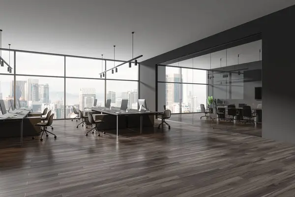 Corner view of office interior with coworking corner, pc computers on desk in row. Glass meeting room with board and armchairs, panoramic window on Kuala Lumpur skyscrapers. 3D rendering