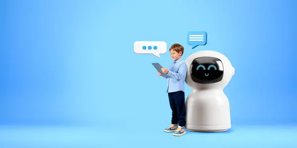 Child using tablet, standing full length near cartoon AI chat bot, speech bubbles on copy space empty blue background. Concept of virtual assistant, technology and machine learning