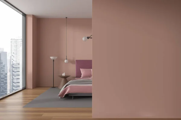 Interior of stylish bedroom with beige walls, wooden floor, comfortable king size bed with red cover and copy space wall on the left. 3d rendering
