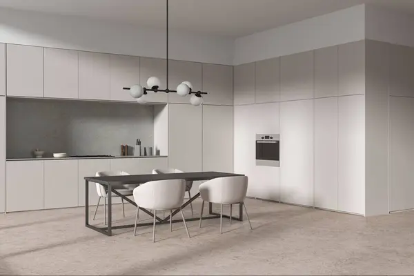 Corner of modern kitchen with beige walls, concrete floor, comfortable cupboards and cabinets with built in cooker and long dining table with chairs. 3d rendering