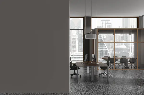 Dark office interior with coworking and glass conference room, chairs and board. Pc computers on table, panoramic window on Bangkok skyscrapers. Mockup empty wall. 3D rendering