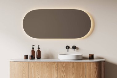 Bej duvarlı şık bir banyo, ahşap tezgahın üzerinde duran yuvarlak lavabo ve üzerinde oval ayna. 3d oluşturma