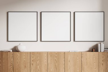 Şık bir oturma odası ahşap büfe, minimalist sanat dekorasyonu ve kitaplarla dolu. Beyaz duvarda sıra sıra dizilmiş kare tuval posterleri. 3B görüntüleme