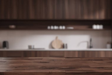 Koyu renkli ahşap ürün masası beyaz duvarları, siyah ahşap dolapları ve dolapları olan şık, bulanık bir mutfakta duruyor. 3d oluşturma