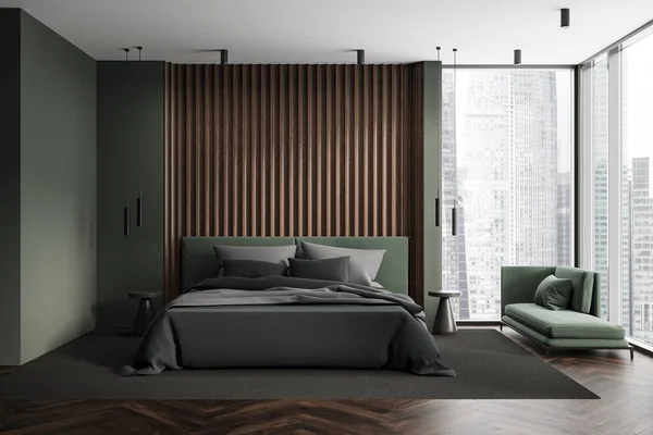 Interior of stylish bedroom with green walls, wooden floor, comfortable king size bed with dark gray cover and cozy armchair standing near panoramic window. 3d rendering