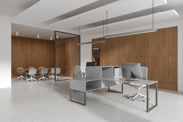 White and wooden office interior with pc desktop on table and chairs, side view glass conference corner with board. Shelf with documents and decoration. 3D rendering