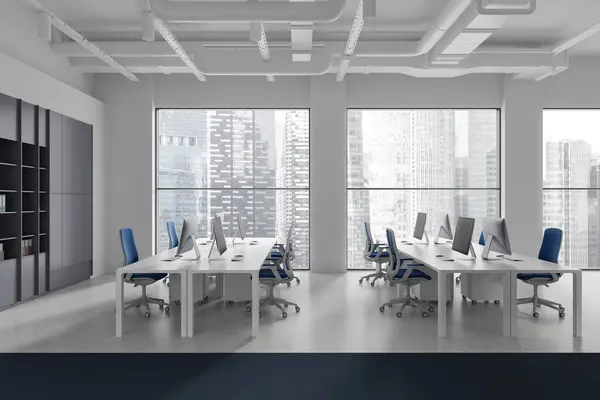 White industrial office interior with pc computers on desk and shelf, light concrete floor. Stylish workplace with panoramic window on Singapore skyscrapers. 3D rendering