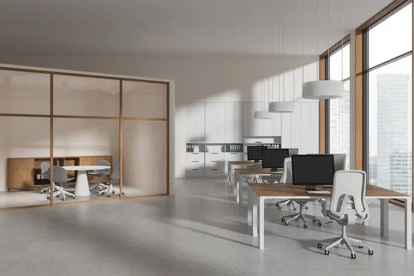 Modern office interior with coworking zone with pc computers on shared desk. Minimalist conference box with chairs and table. Panoramic window on skyscrapers. 3D rendering