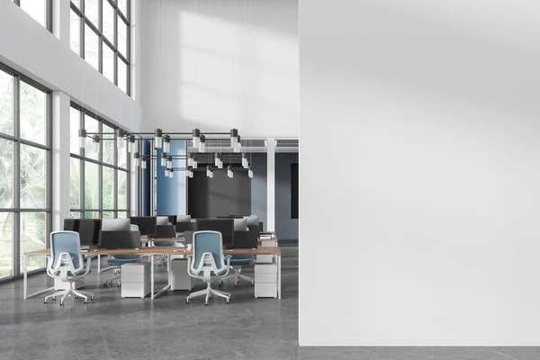 Stylish business interior with coworking zone, pc computers on desk in row. Blue and white corporate loft space with panoramic window on tropics. Mock up empty wall partition. 3D rendering
