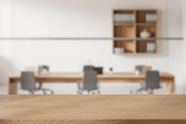 Empty wooden table on blurred background of office conference room. Board and armchairs, laptop and shelf with documents. Mockup for product display. 3D rendering
