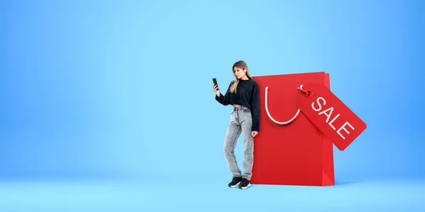 Concentrated Woman Looking Phone Standing Big Red Shopping Bag Copy — Stock Photo, Image