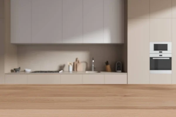 Holztisch Auf Unscharfem Hintergrund Der Beigen Kücheneinrichtung Kochschrank Mit Spüle — Stockfoto