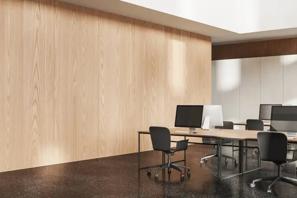 Wooden office interior with pc computers on desk and chairs in row, granite floor. Cozy work corner with furniture and technology. Empty copy space wall. 3D rendering