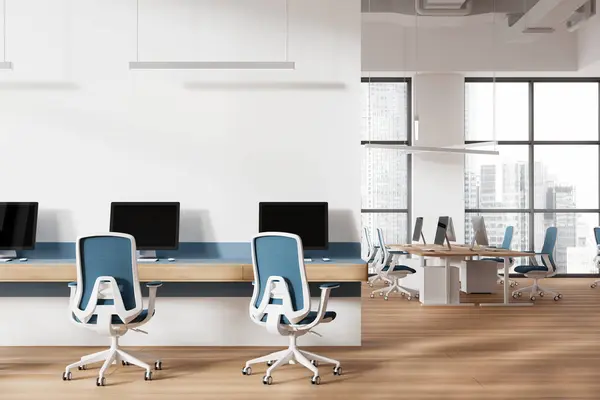 White and wooden office loft interior with pc monitors, long table and coworking zone with armchairs and desk on hardwood floor. Panoramic window on Singapore skyscrapers. 3D rendering