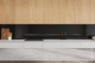 Ev mutfağının iç kısmının bulanık arka planında boş taş bir masa mutfak gereçleri ve fırınla pişirme alanı. Ürün gösterimi için kopyalama alanı oluşturun. 3B görüntüleme